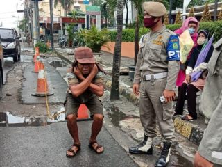 Satpol PP Kota Medan saat memberikan sanksi bagi yang tidak membawa KTP dikenakan sanksi push up atau shit up.
