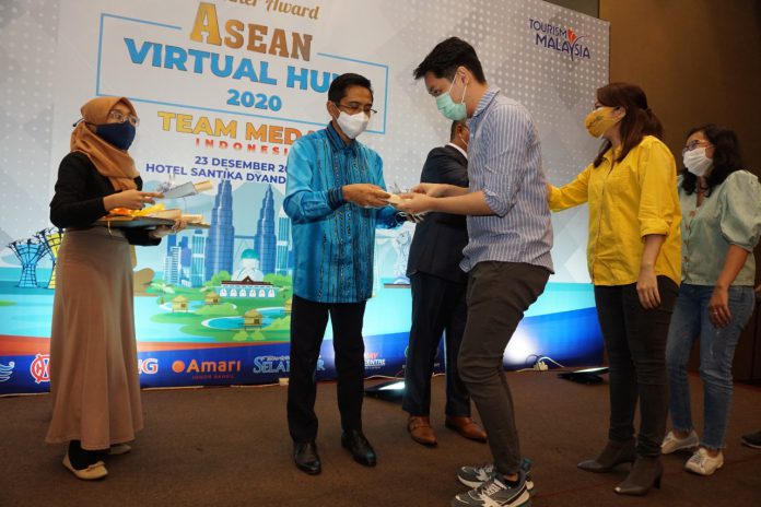 Aiyub Omar menyerahkan hadiah Malaysia Virtual Hunt 2020 kepada pemenang dari Medan di Hotel Santika Rabu lalu.