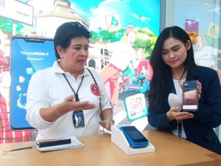 Dua orang karyawan Permata Bank sedang memaparkan cara pengambilan nomor antrian di kantor cabang. Foro:kaldera/reza