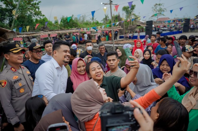 Walikota Medan, Bobby Nasution berfoto bersama dengan masyarakat Kecamatan Medan Marelan, Sabtu (11/3/2023). Foto:Dinas Kominfo Kota Medan