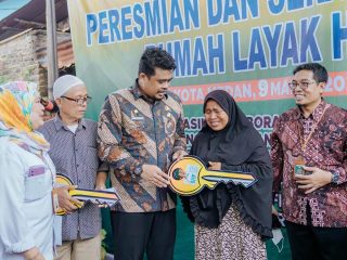 Walikota Medan, Bobby Nasution menyerahkan kunci rumah warga yang telah selesai diperbaiki menjadi layak huni di Kecamatan Medan Denai, Kamis (9/3/2023).